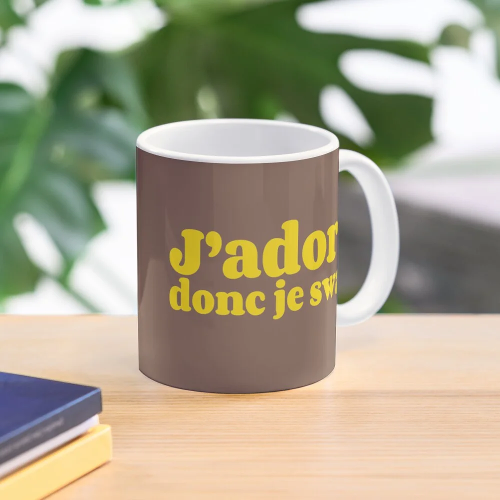 Brown mug with the yellow text 'J'adore, donc je swag.'